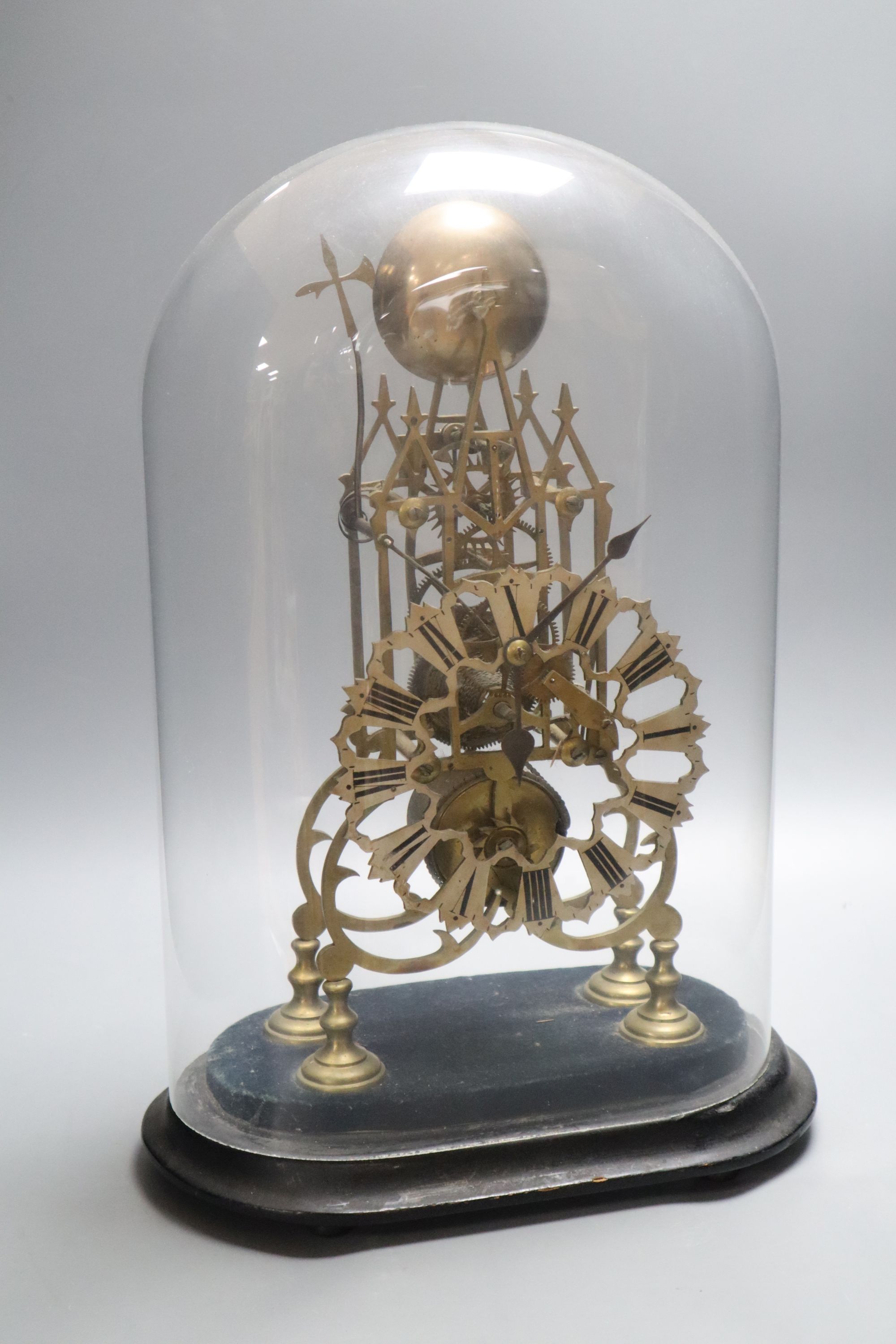 A Victorian brass skeleton clock, under dome